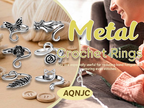 Collection of adjustable metal crochet rings with butterfly, rose, feather, and cat motifs, displayed with yarn and buttons.
