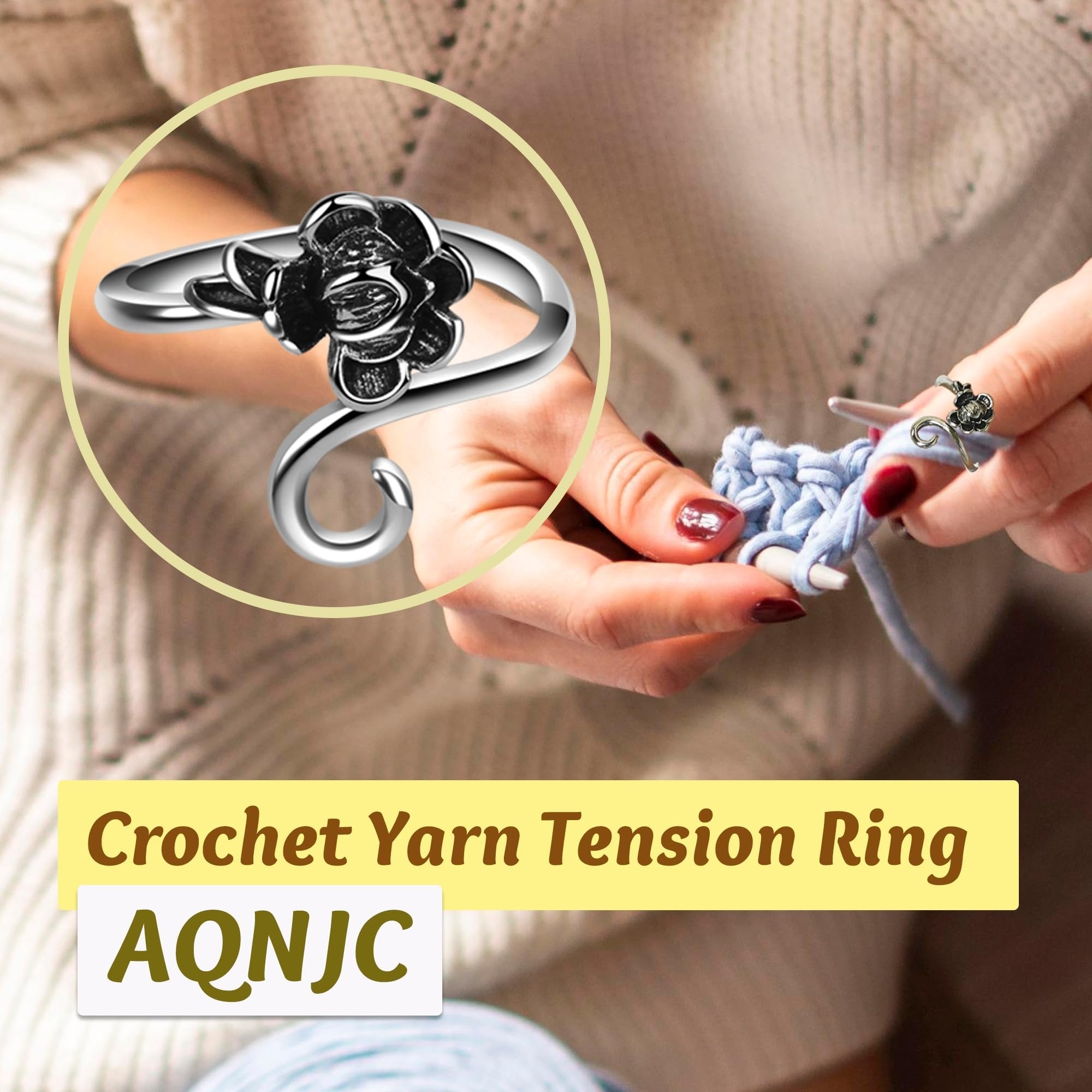 Close-up of a person's hands crocheting with a silver yarn tension ring featuring a rose motif on their finger.