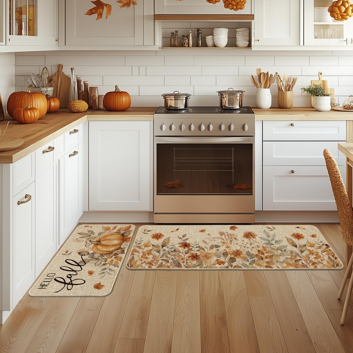 Two fall-themed kitchen mats with pumpkins and floral designs on a wooden floor in a kitchen setting.