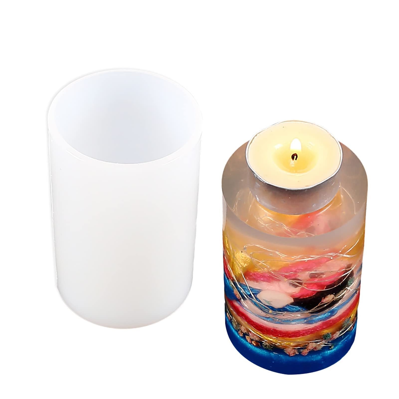 White silicone cylinder mold next to a finished candle in a clear resin mold with colorful inclusions and fairy lights