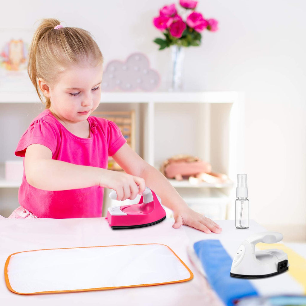 Young girl in pink shirt using a pink mini craft iron on a white surface with an ironing cloth and spray bottle nearby.