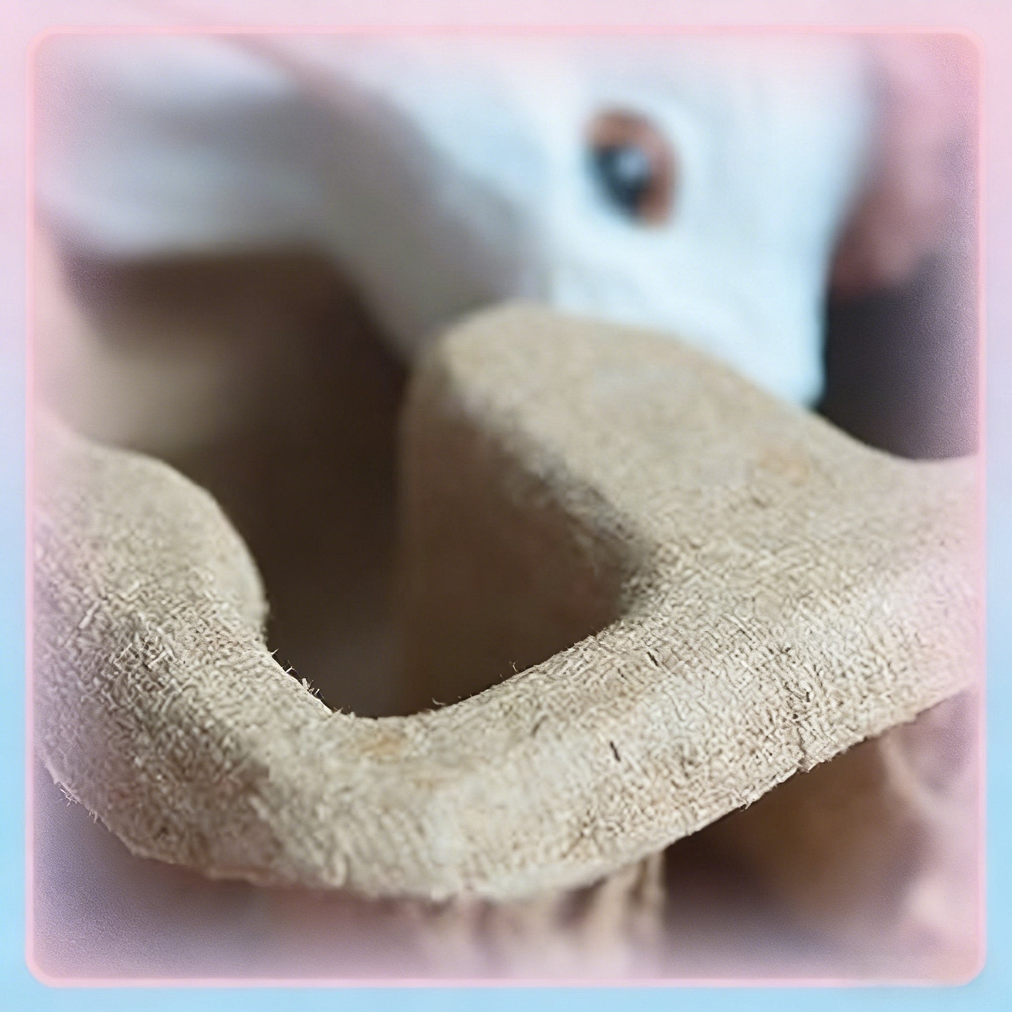 Close-up of a textured beige protective insert with a blurred white object and a brown eye in the background.