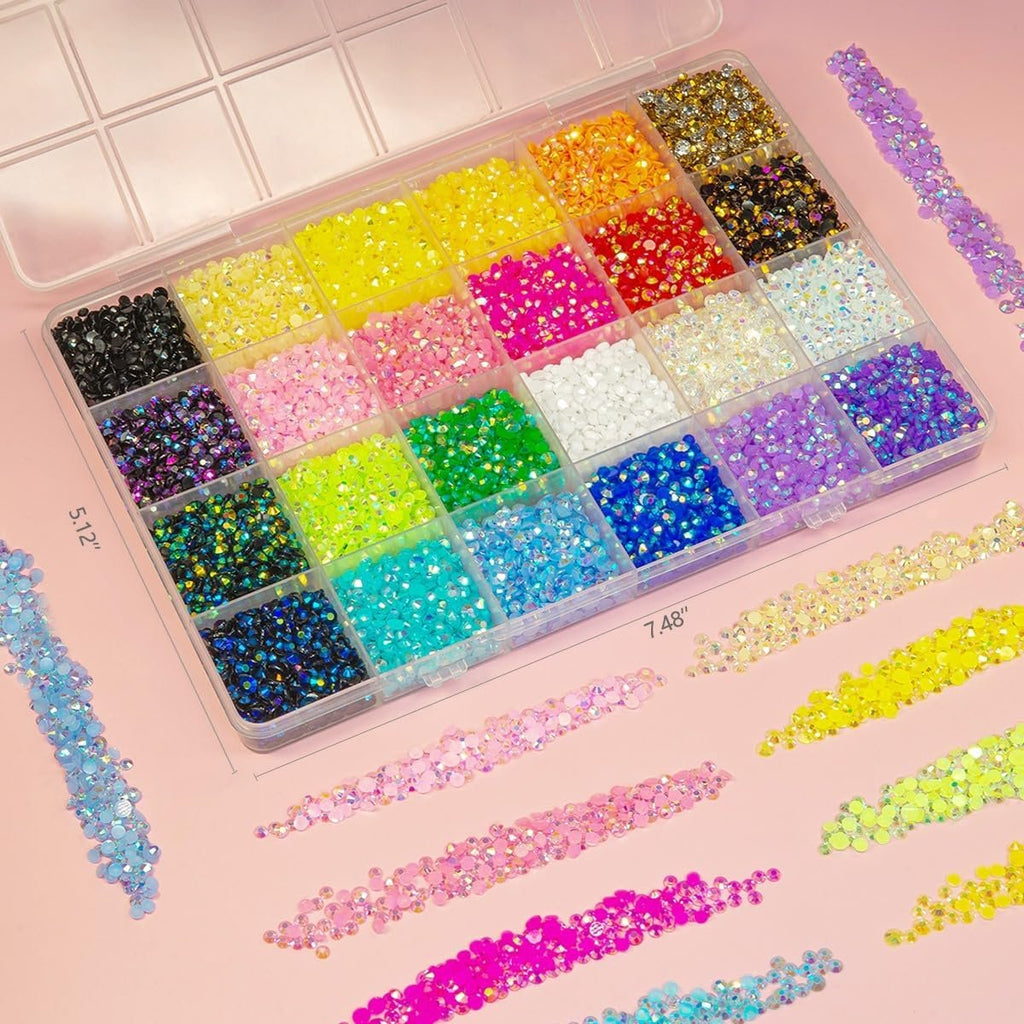 Flatback rhinestones in a clear organizer case with dimensions 5.12" and 7.48", surrounded by loose rhinestones.
