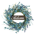 Artificial blue forsythia wreath with a wooden welcome sign in the center, on a white background.