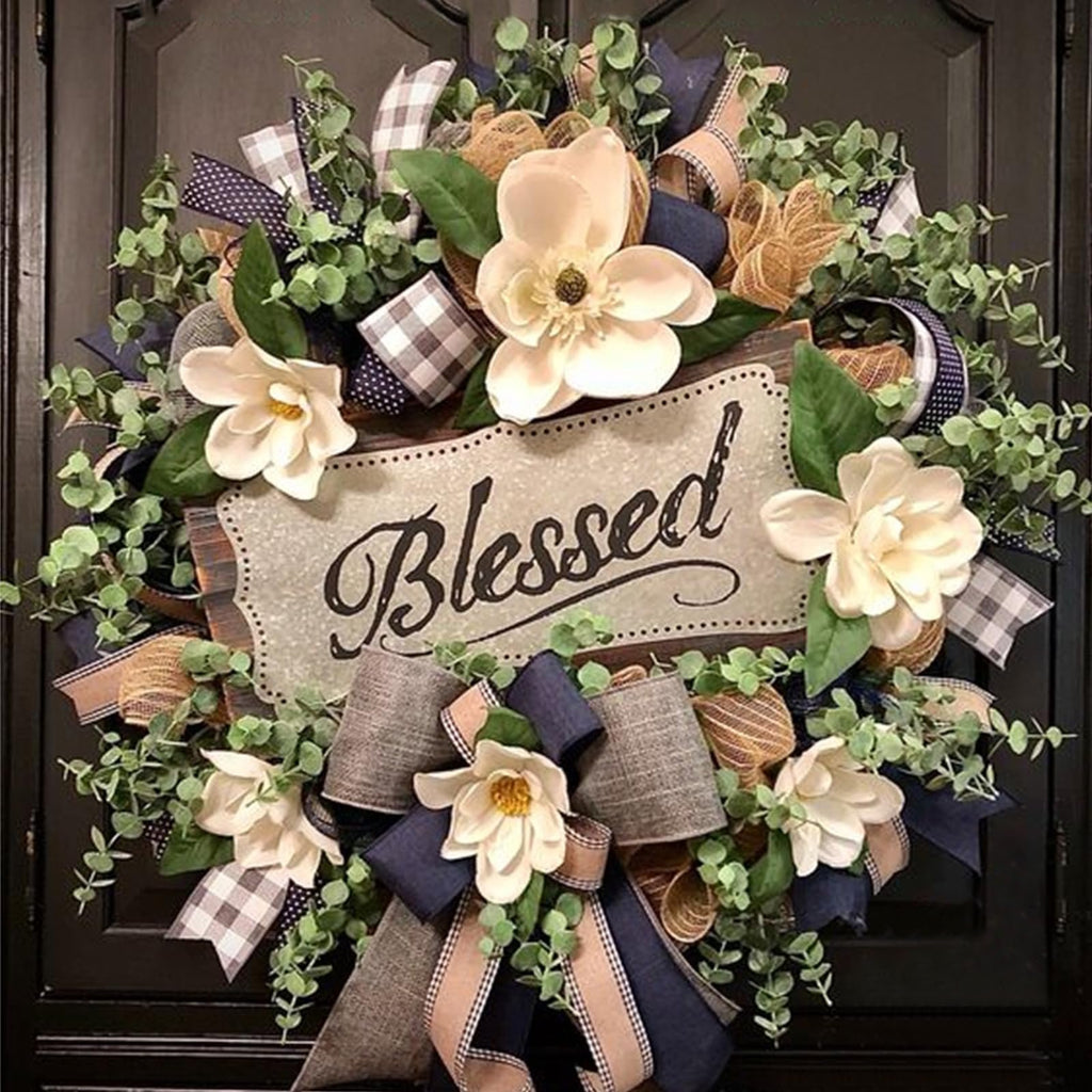 Magnolia wreath with buffalo plaid bow and 'Blessed' wooden plaque, decorated with greenery and ribbons.