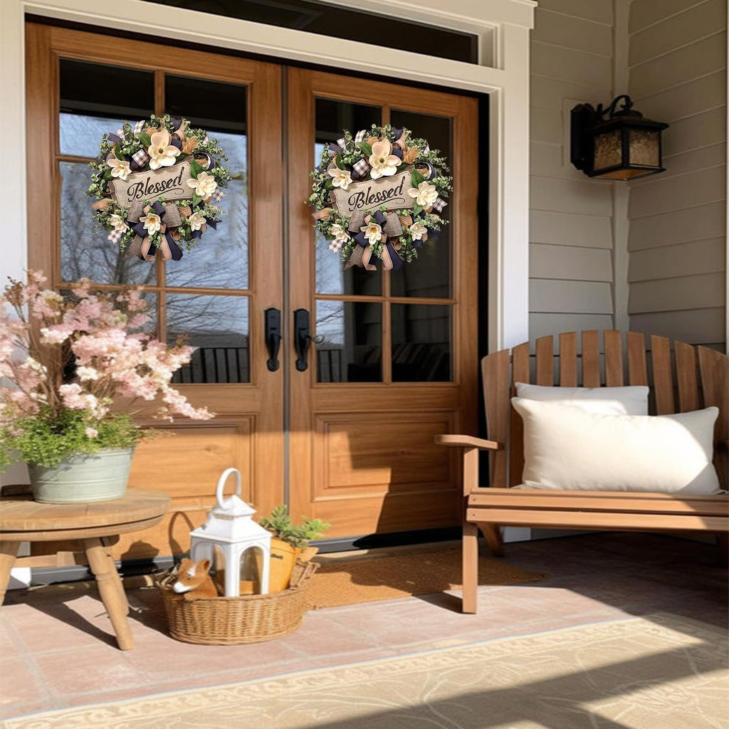 Two white magnolia wreaths with buffalo plaid bows and 'Blessed' plaques hang on double doors.