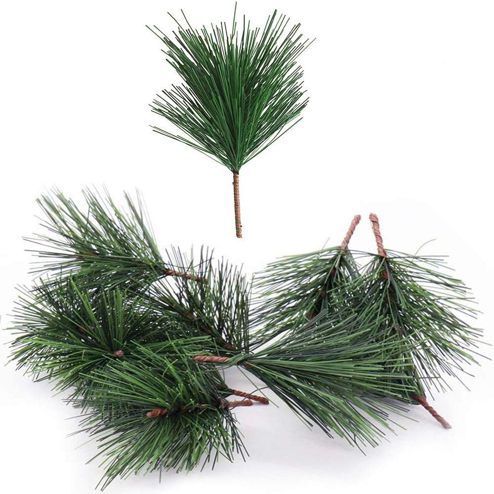 Artificial green pine needle stems with wire twig bases on a white background