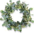 20-inch artificial eucalyptus wreath with silk leaves and small white flowers on a metal base, shown from a top-down angle on a white background.