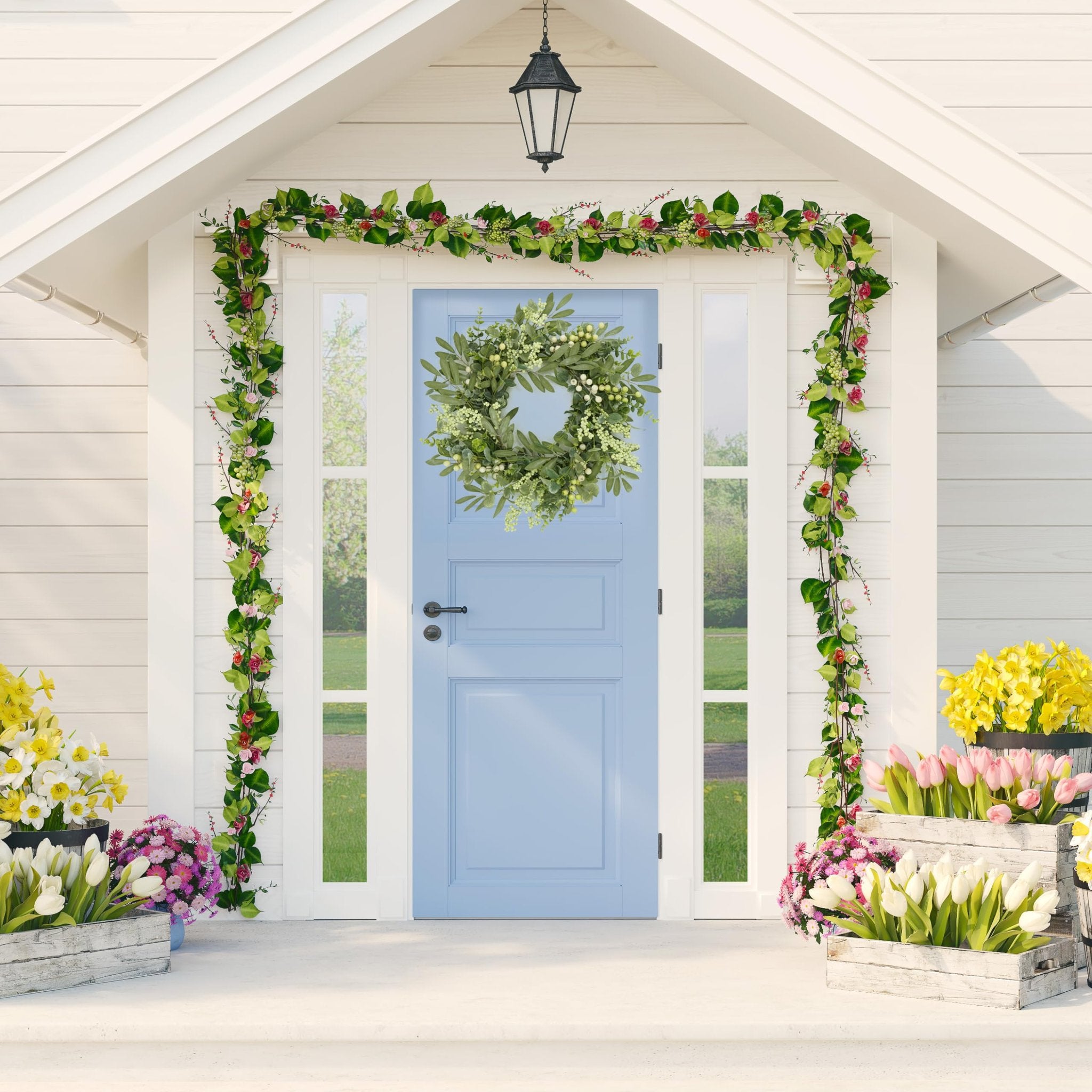 Eucalyptus and berry wreath on a light blue door, flanked by floral garlands and potted flowers on a porch.