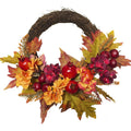 Autumn wreath with pomegranates, apples, maple leaves, silk flowers on a natural vine base.