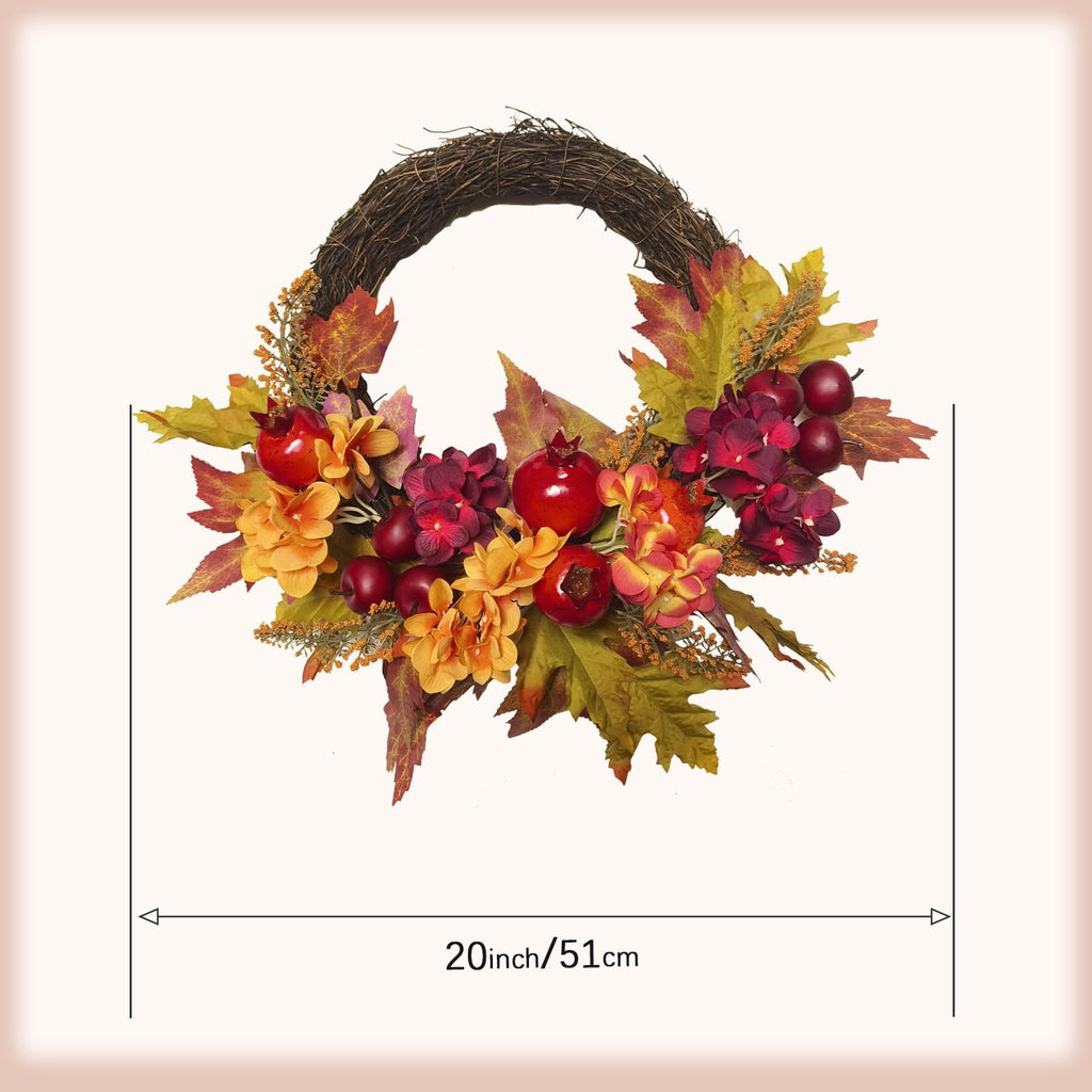 20 inch fall wreath with apples, pomegranates, maple leaves, silk leaves and flowers on a natural vine base.