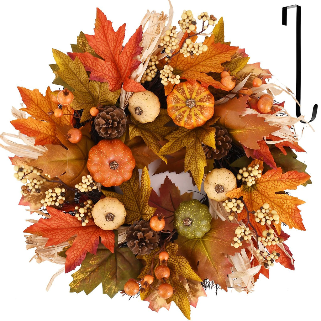 Fall wreath with pumpkins, maple leaves, berries, pine cones, and a black hook on a white background.