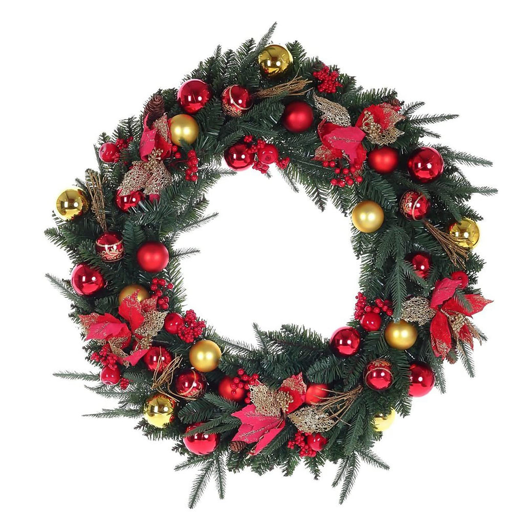 Decorated Christmas wreath with red and gold ornaments, red berries, and pinecones on a white background.