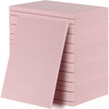 Stack of 20 pink rubber carving blocks for stamp making, one block leaning against the stack.