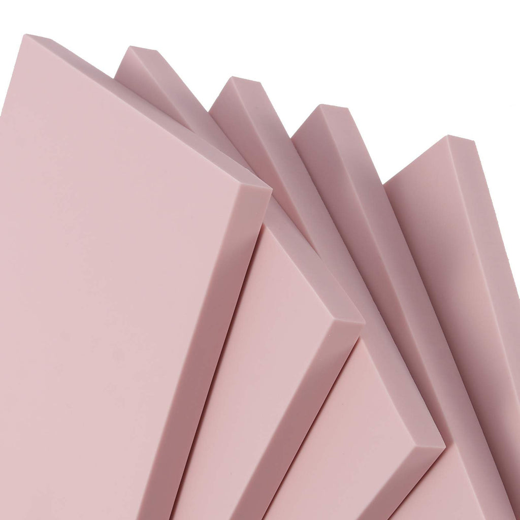 Stack of pink rubber carving blocks for stamp making, close-up angled view
