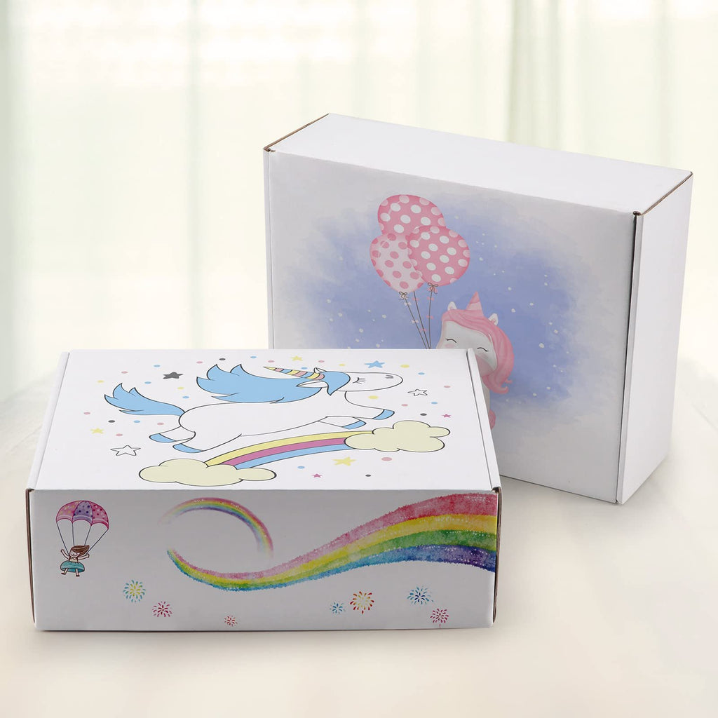 Two white corrugated cardboard shipping boxes with unicorn and rainbow designs, one in foreground, one in background.