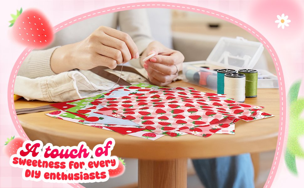 Hands sewing on strawberry print fabric squares with spools of thread and a sewing kit in the background.