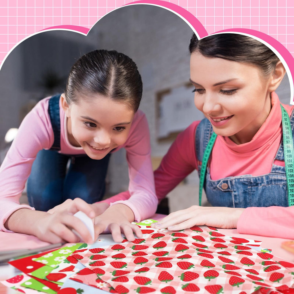 Mother and daughter crafting with strawberry patterned fabric squares