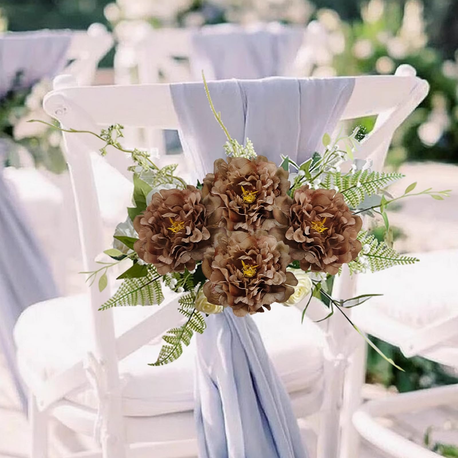 Brown artificial peony flowers with green foliage tied to a white chair with light blue fabric.