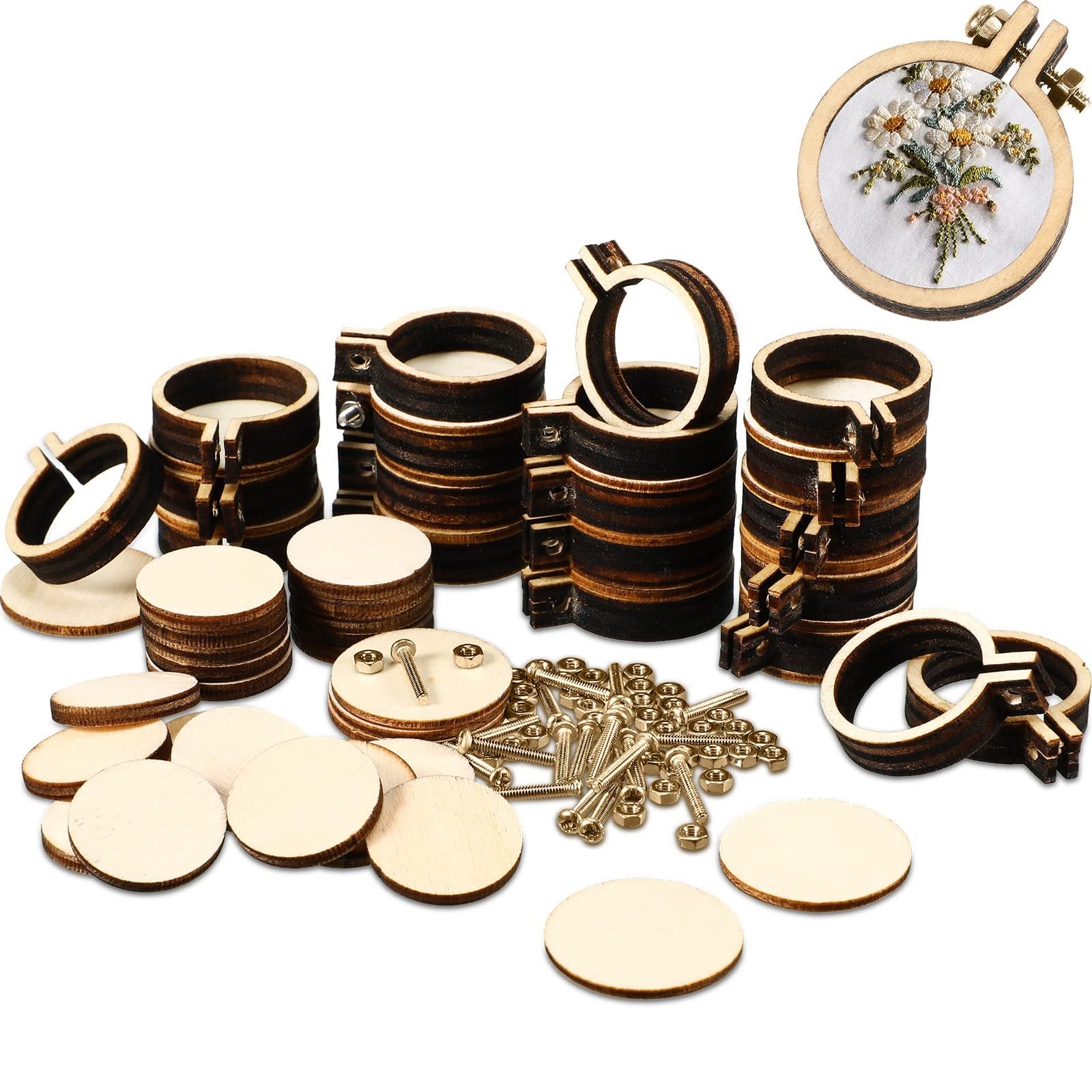Mini wooden embroidery hoops and round wooden discs scattered on a white background, with one hoop showing a floral embroidery.