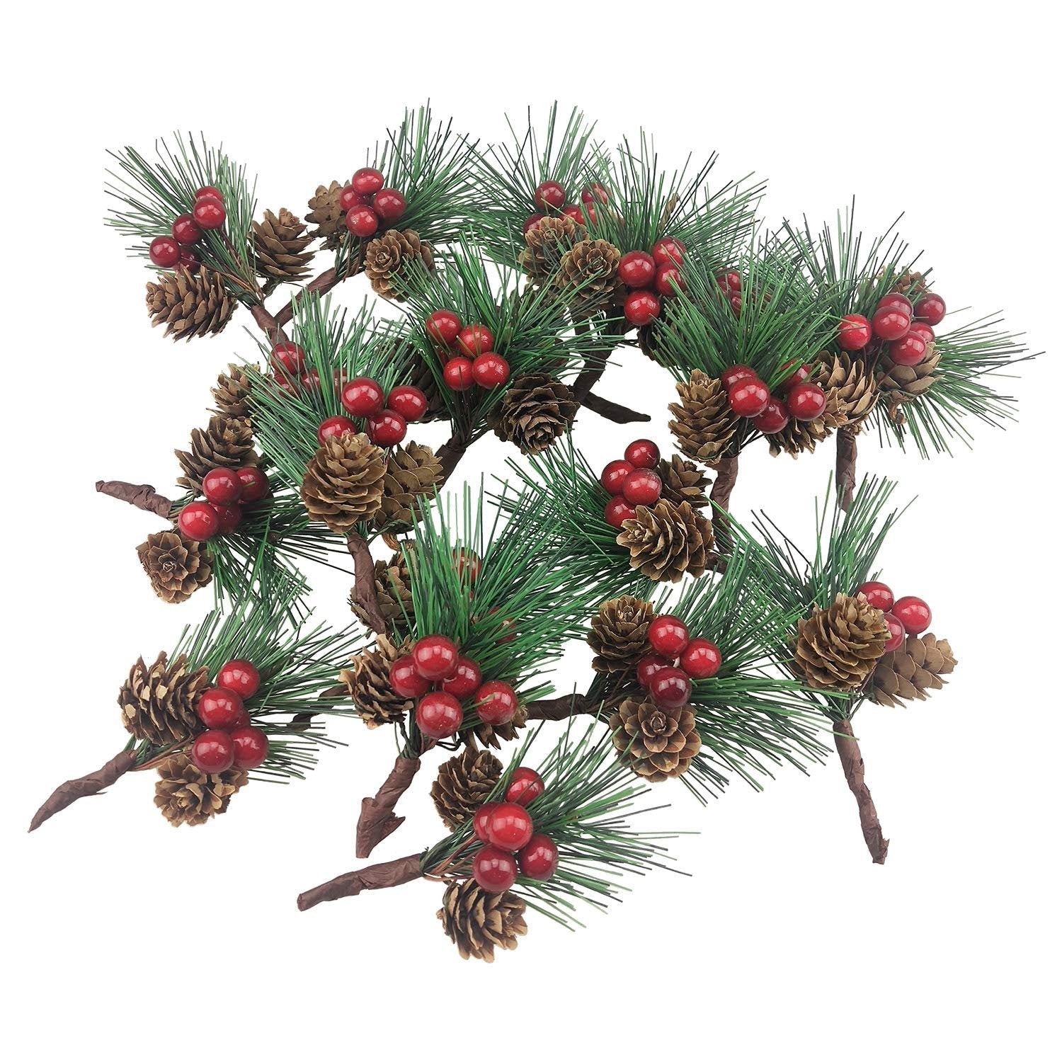 Artificial pine picks with red berries and pinecones on white background