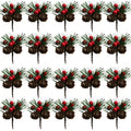 Multiple artificial pine picks with red berries and pinecones arranged in a grid on a white background.