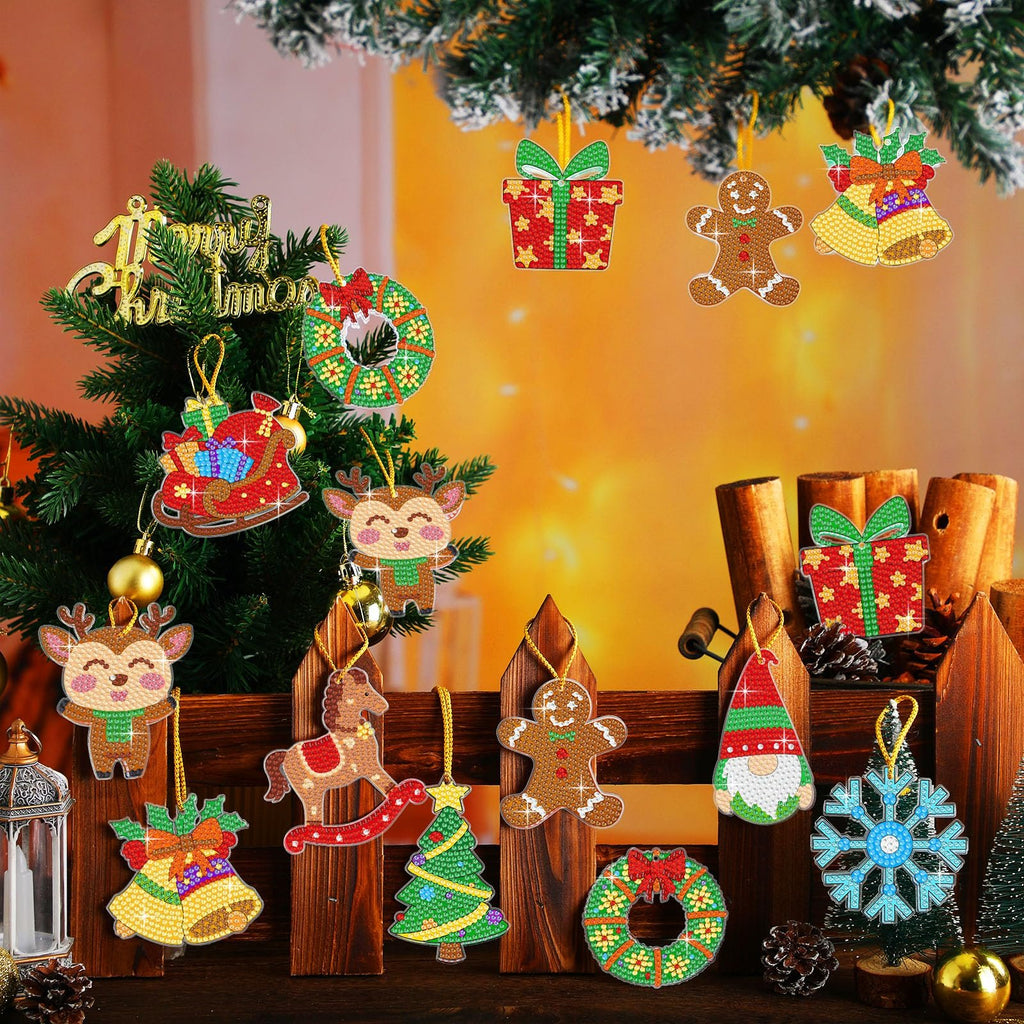 Christmas diamond painting ornaments hanging on a decorated tree and fence, featuring reindeer, gingerbread man, gifts, bells, wreath, sleigh, rocking horse, gnome, and snowflake designs.