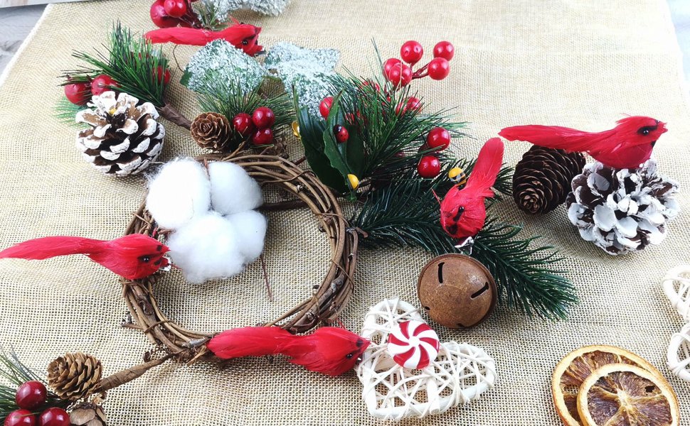 Christmas cardinal ornaments with pinecones, berries, cotton, and a bell on burlap