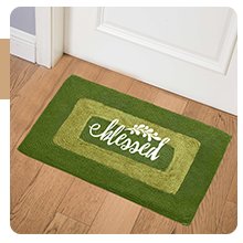 Green welcome mat with concentric rectangular borders and the word 'blessed' in white script with a small leafy branch design.