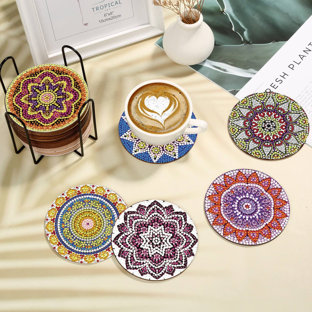 Mandala diamond art painting coasters in a holder with a cup of coffee on a coaster