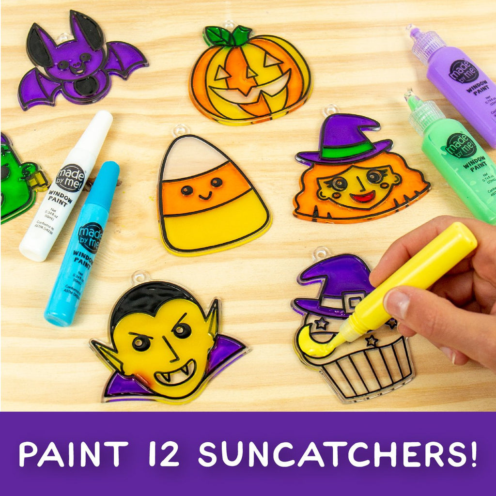 Halloween window art kit with paint tubes and suncatcher frames including a bat, pumpkin, candy corn, witch, vampire, and cupcake.