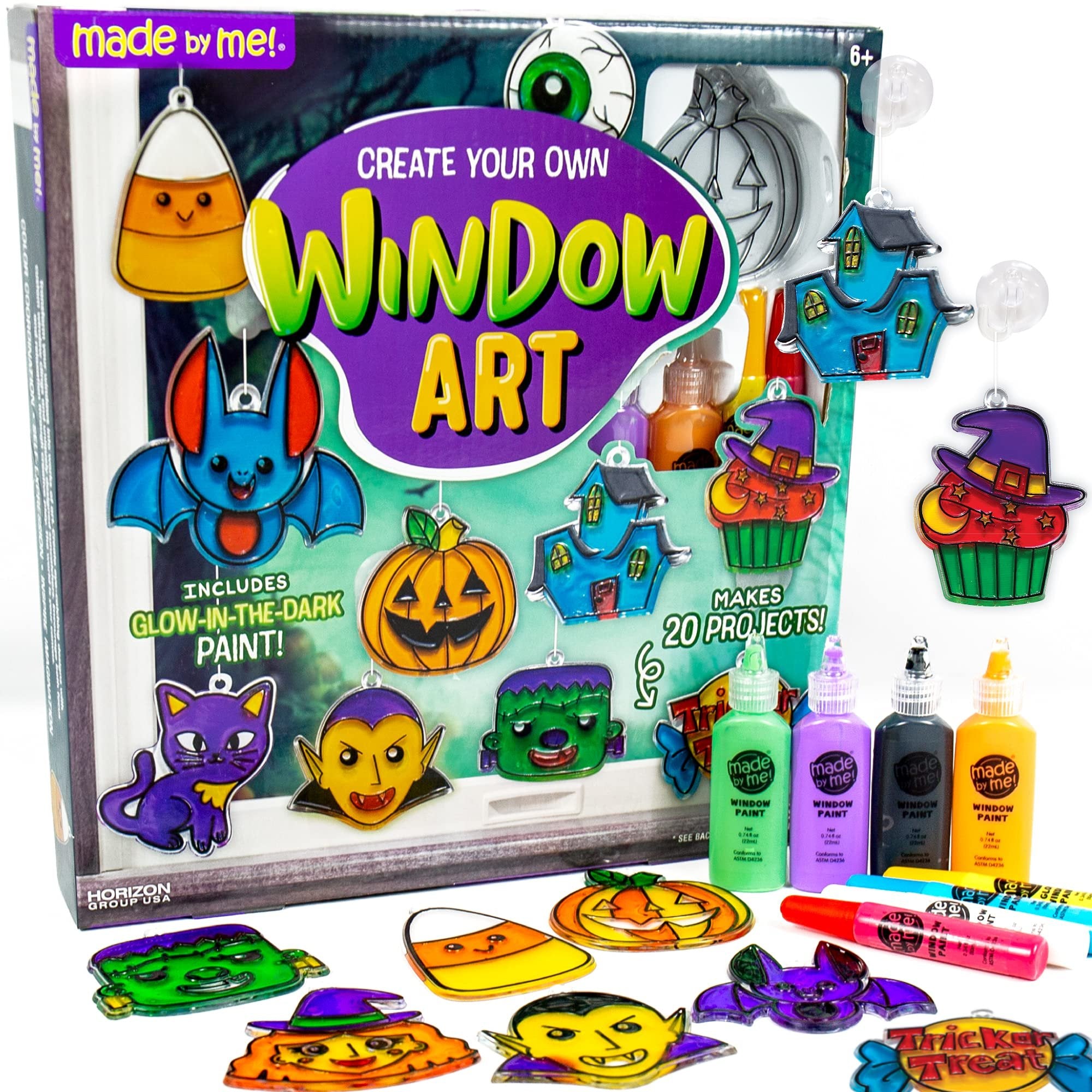 Halloween window art kit with various suncatcher frames and glow-in-the-dark paints, including candy corn, bat, pumpkin, and vampire designs.