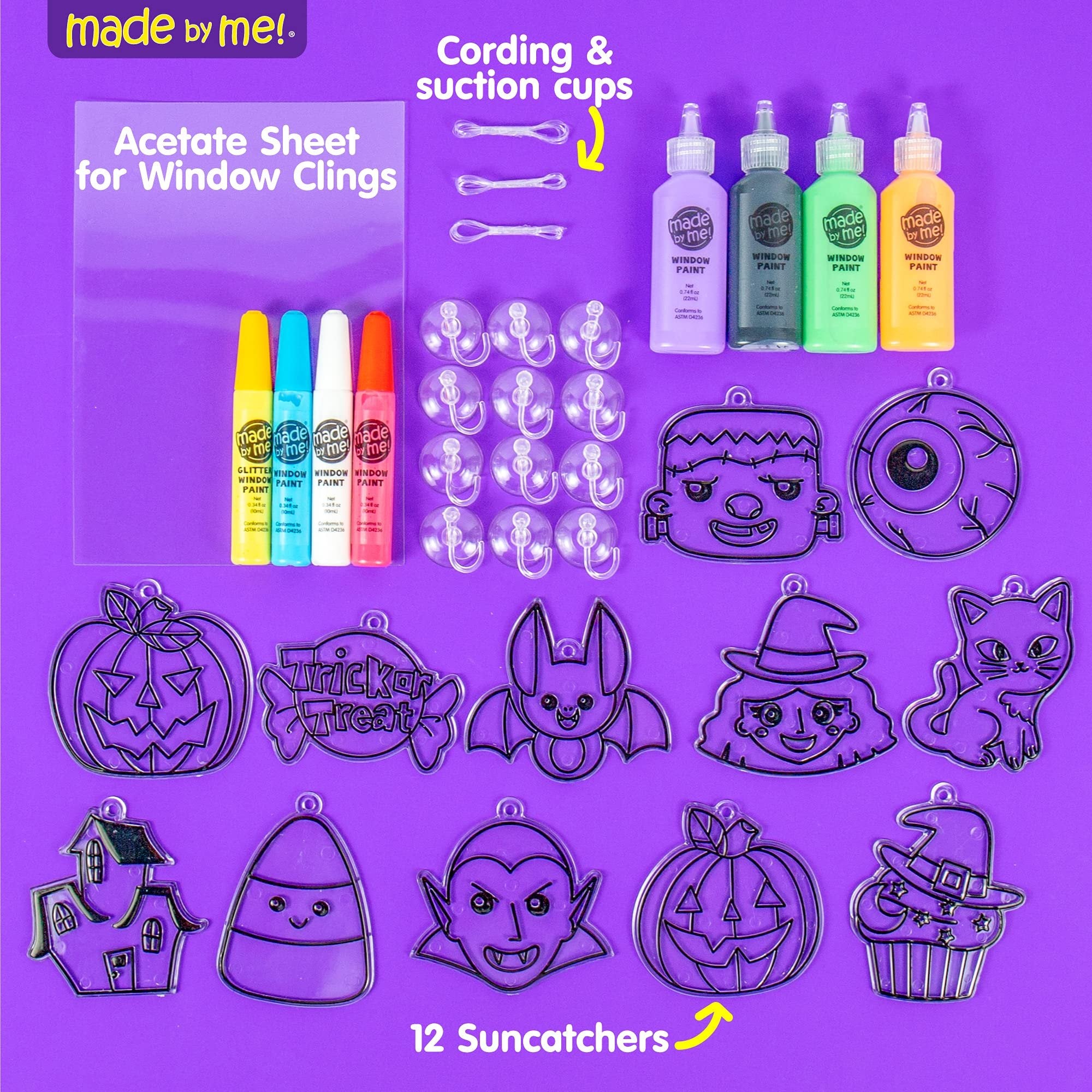 Halloween window art kit contents including paint tubes, suncatcher frames, cording, and suction cups on a purple background.