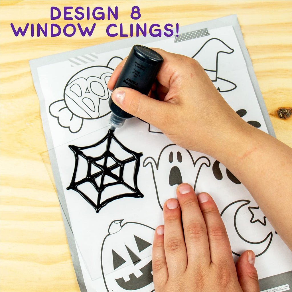 Hand applying black paint to a spider web design on a Halloween window cling template.