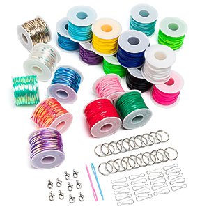 Assorted spools of colorful plastic lacing cord, keychain rings, clasps, and needles on a white background.