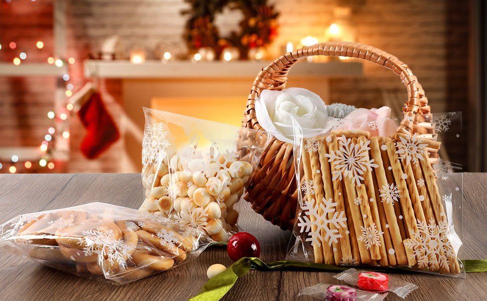 Christmas-themed cellophane bags filled with cookies and treats, arranged in a festive setting with a fireplace and stockings.