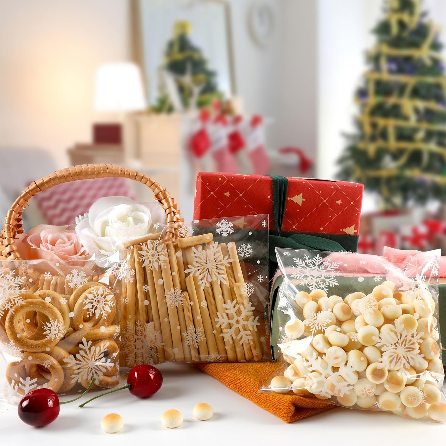 Christmas-themed cellophane bags filled with cookies and snacks, arranged with gifts and a Christmas tree in the background.