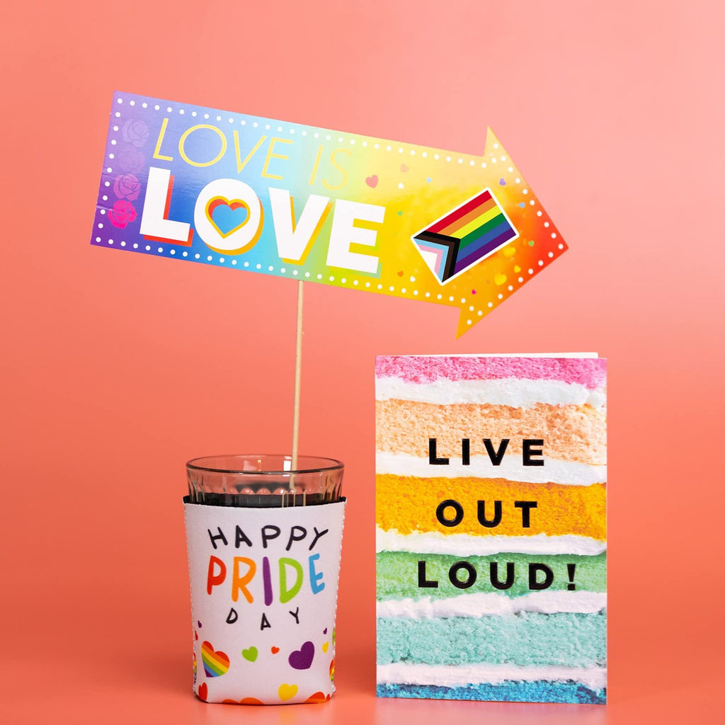 Pride themed arrow sign and cake slice graphic with text, next to a glass with a pride themed sleeve.