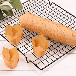 Natural tulip cupcake liners made of unbleached parchment paper on a cooling rack