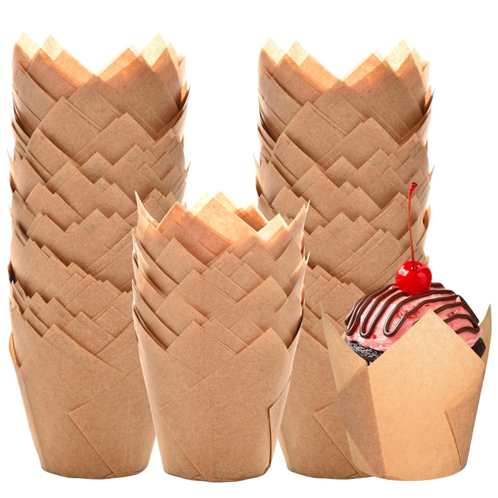 Stacks of natural tulip cupcake liners with one liner holding a decorated cupcake topped with a cherry.