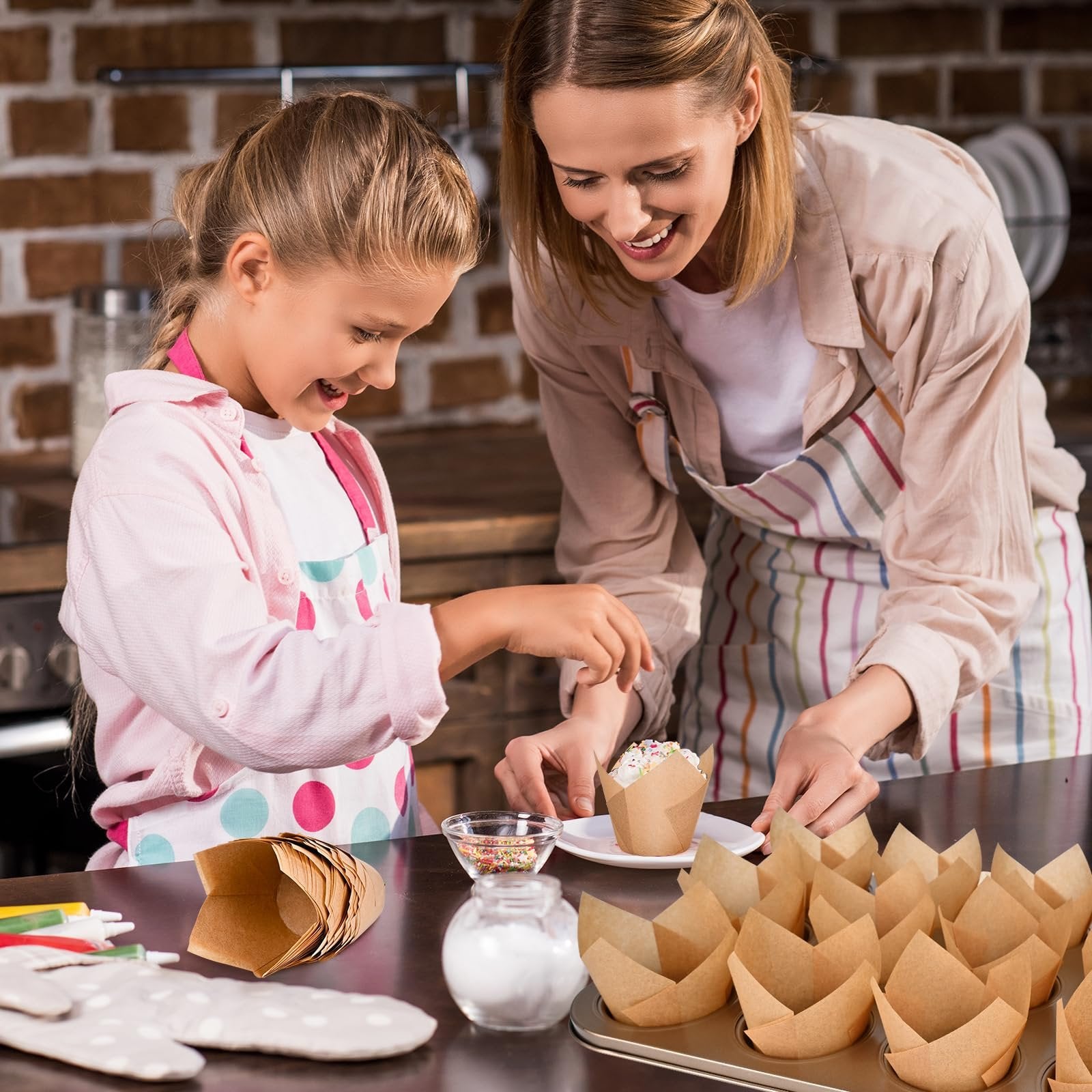 Mother and daughter decorating a cupcake with natural tulip cupcake liners in a kitchen setting.