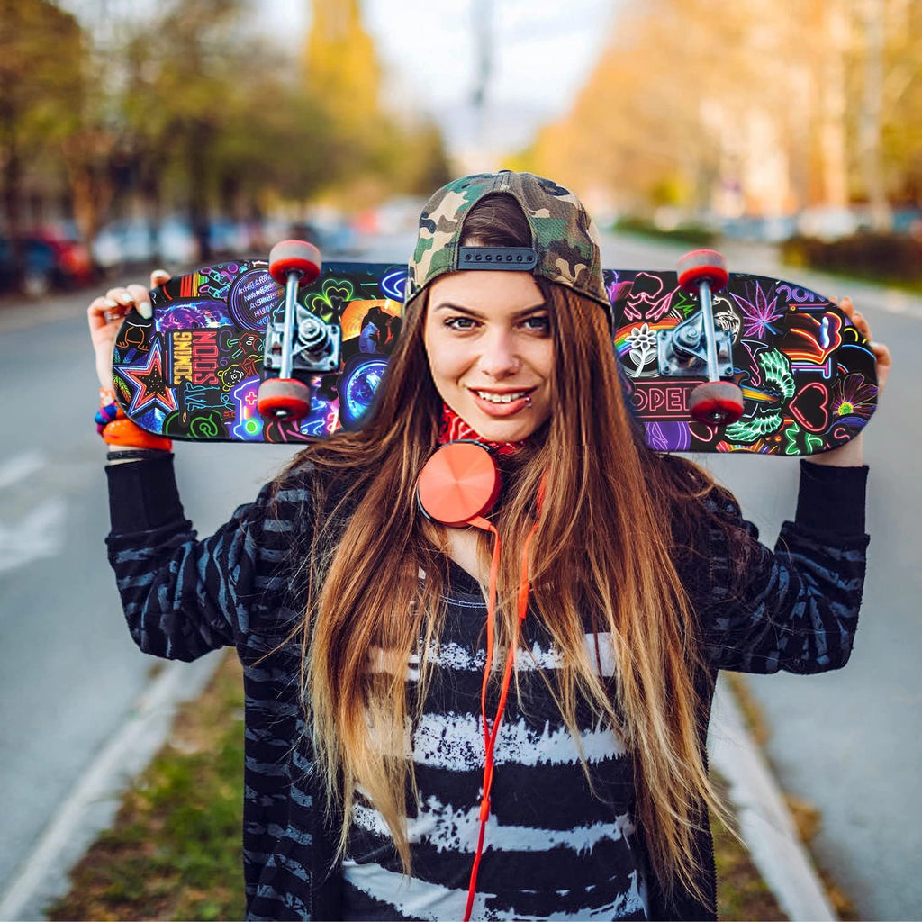Woman holding a skateboard with colorful neon stickers, outdoors on a street