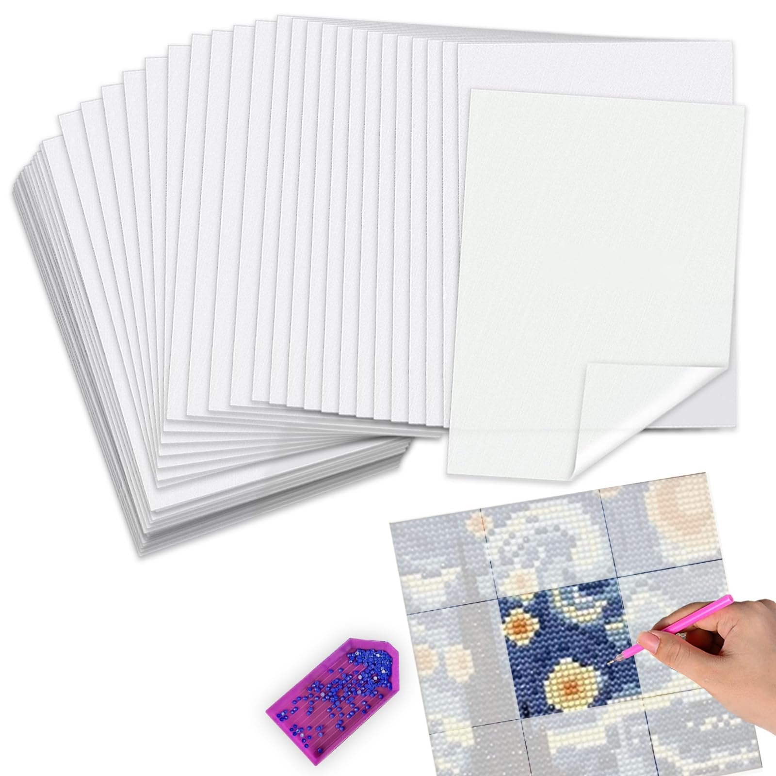 Stack of white release paper sheets for diamond painting, with a diamond painting in progress and a pink tool.
