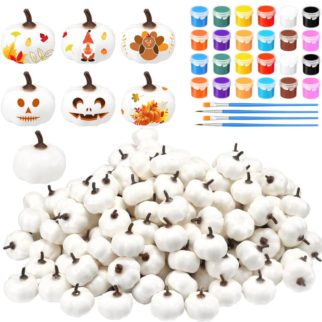 White foam pumpkins with assorted decorative designs, paints, and brushes for crafting