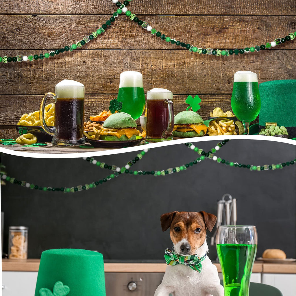 St. Patrick's Day themed scene with green beer, burgers, snacks, and a dog wearing a bow tie, with festive garland overhead.