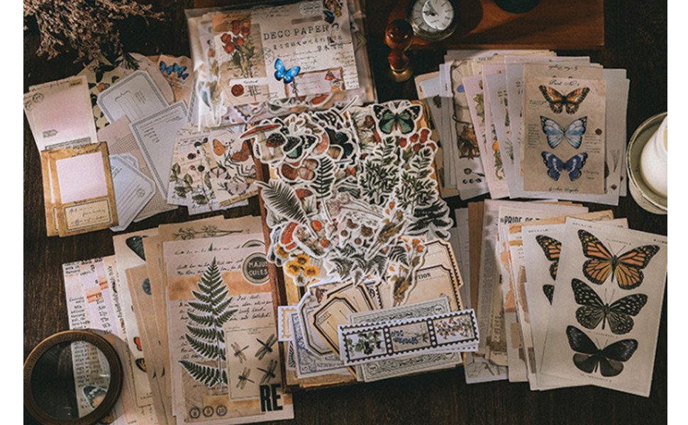 Vintage scrapbooking kit with assorted stickers, papers, and decorative elements including butterflies and ferns.