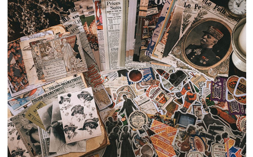 Scrapbooking kit with vintage papers, stickers, and decorative elements laid out flat.