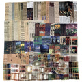 Flat lay of a vintage scrapbooking kit featuring various papers, stickers, and art prints with classical and impressionist themes.