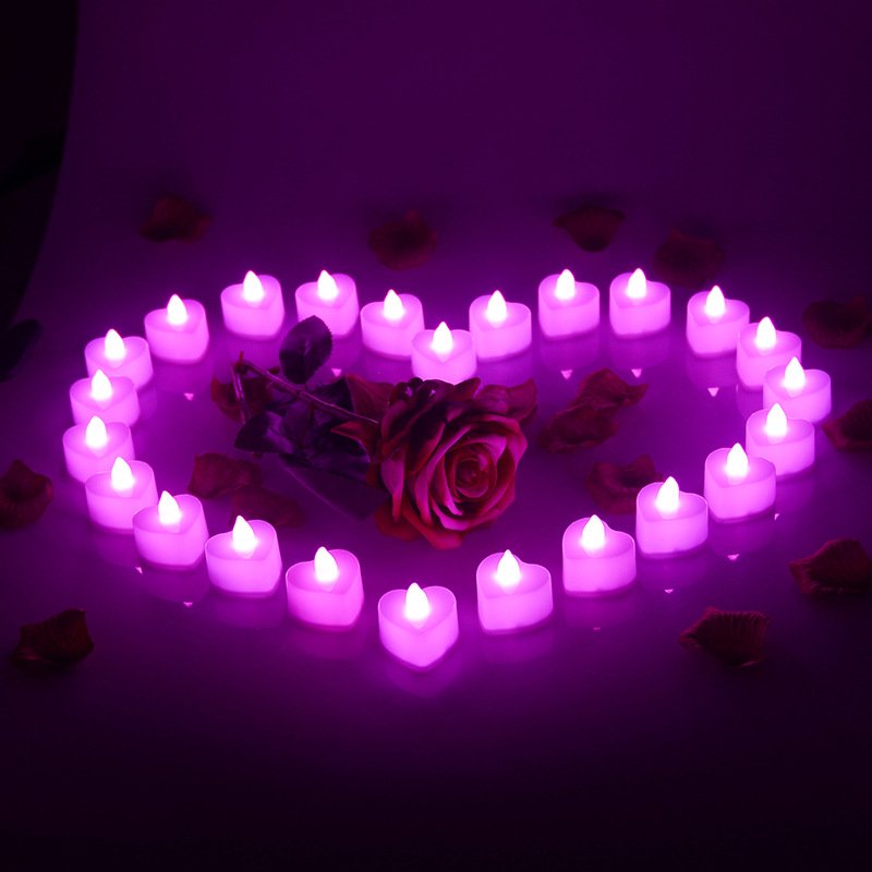 Heart-shaped LED tea lights arranged in a heart shape with a rose and petals, glowing purple.