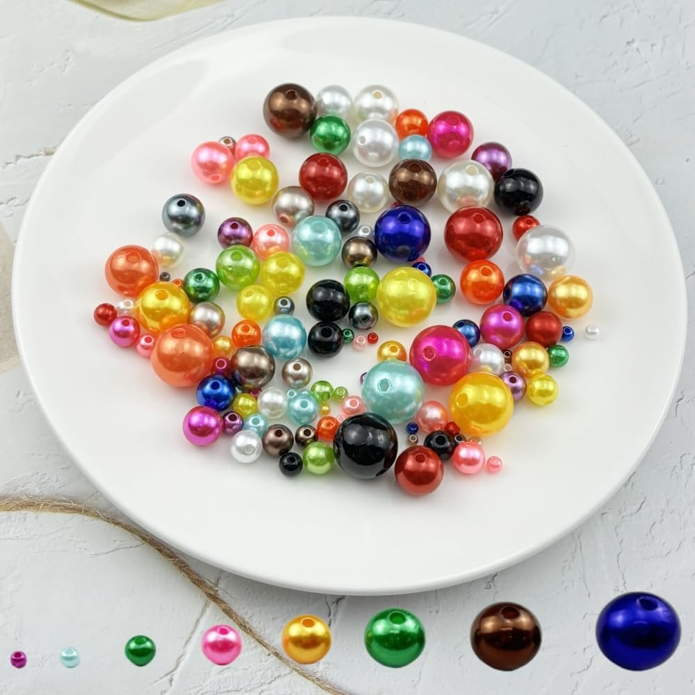 Assorted colorful resin pearl beads with holes scattered on a white plate, with individual bead color swatches below.